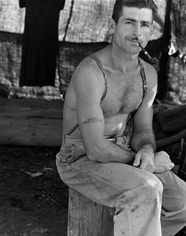 Image: Photo of unemployed lumber worker with social security number tattooed on his arm taken by Dorothea Lange in 1939. From the Library of Congress.