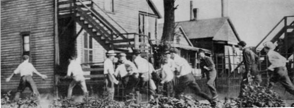 Image: Photo of white Chicagoans looking for African Americans during the race riots of 1919. From the Wikimedia Commons.